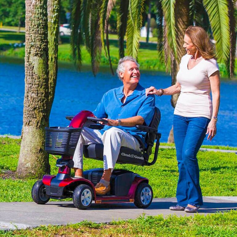 Senior man riding a mobility scooter in Gatlinburg with assistance, showcasing RideOn’s Gatlinburg scooter rentals.